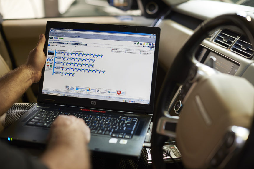 Jaguar Land Rover diagnostic software running on a laptop inside a Range Rover