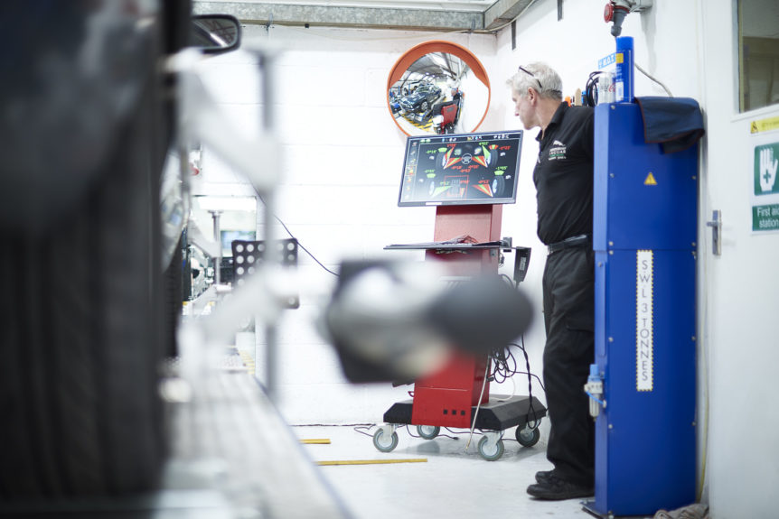 A technician at the test equipment in the MOT bay